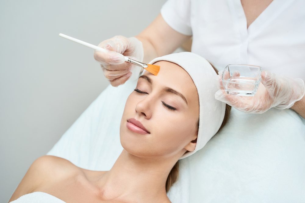 Cosmetology beauty procedure. Young woman skin care. Beautiful female person. Rejuvenation treatment. Facial chemical peel therapy. Clinical healthcare. Doctor hand. Dermatology cleanser.